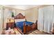 Charming bedroom featuring a wood bed, hardwood floors, a nightstand, and bright natural light at 992 Brian Ln, Forest Park, GA 30297