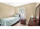 Cozy bedroom features wood-look flooring, a twin bed, a large window, and a small accent table at 992 Brian Ln, Forest Park, GA 30297