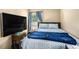 Cozy bedroom with a plush queen bed, large-screen television, and a bedside table with lamp at 992 Brian Ln, Forest Park, GA 30297