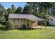 Charming home featuring a covered carport, mature trees, and a well-maintained front yard at 992 Brian Ln, Forest Park, GA 30297