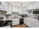 Bright kitchen with white cabinets, a modern microwave, and wood-look flooring at 992 Brian Ln, Forest Park, GA 30297