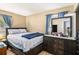 The main bedroom has a dark wood dresser with a mirror and a comfortable queen size bed at 992 Brian Ln, Forest Park, GA 30297