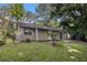 Backyard with large yard, mature trees and a small patio at 22 Cardinal Ln, Jonesboro, GA 30238
