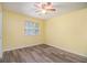 This bedroom has hardwood floors, a ceiling fan, and a window bringing in natural light at 22 Cardinal Ln, Jonesboro, GA 30238