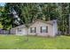 Traditional home featuring a lush green lawn, exterior shed, and side yard at 22 Cardinal Ln, Jonesboro, GA 30238