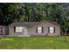 Charming single-story home features a well-maintained lawn and a convenient storage shed at 22 Cardinal Ln, Jonesboro, GA 30238