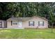 Charming single-story home features a well-maintained lawn and a convenient storage shed at 22 Cardinal Ln, Jonesboro, GA 30238