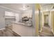 Kitchen with stone counter tops and stainless steel appliances open to hallways at 22 Cardinal Ln, Jonesboro, GA 30238
