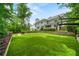 Beautiful backyard with green lawn, a basketball court, and landscaping at 4048 Navajo Trl, Brookhaven, GA 30319