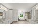 Bright bathroom featuring double sinks, soaking tub, and glass shower at 4048 Navajo Trl, Brookhaven, GA 30319