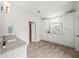 Bright bathroom with marble countertops, white cabinetry, and wood-look flooring at 4048 Navajo Trl, Brookhaven, GA 30319