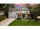 Charming two-story home with landscaped yard, covered porch, and attached two-car garage at 4048 Navajo Trl, Brookhaven, GA 30319