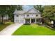 Charming two-story home with a manicured front yard and a two-car garage at 4048 Navajo Trl, Brookhaven, GA 30319