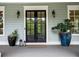 Inviting front door with sidelights and potted plants adding charm at 4048 Navajo Trl, Brookhaven, GA 30319