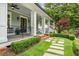 Charming front porch with swing, landscaping, and stone pathway at 4048 Navajo Trl, Brookhaven, GA 30319