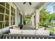 Relaxing front porch with swing, white columns, and ceiling fans at 4048 Navajo Trl, Brookhaven, GA 30319