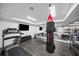 Well-equipped home gym featuring a treadmill, punching bag, mirrored walls, and mounted television at 4048 Navajo Trl, Brookhaven, GA 30319