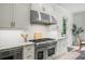 Chef's kitchen with stainless steel range, granite countertops, and white subway tile backsplash at 4048 Navajo Trl, Brookhaven, GA 30319