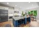 Bright kitchen with granite countertops, stainless steel appliances, an island with seating, and a dining area at 4048 Navajo Trl, Brookhaven, GA 30319