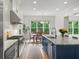 Modern kitchen with stainless appliances, granite counters, and a view to the dining area at 4048 Navajo Trl, Brookhaven, GA 30319