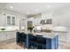 Gourmet kitchen featuring white cabinets, stainless steel appliances, and a large island with bar stools at 4048 Navajo Trl, Brookhaven, GA 30319