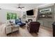 Comfortable living room with a stone fireplace, ceiling fan, and built-in shelving at 4048 Navajo Trl, Brookhaven, GA 30319