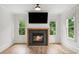 Inviting living room with fireplace, hardwood floors, and ample natural light, perfect for relaxing or entertaining at 4048 Navajo Trl, Brookhaven, GA 30319