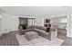 Large basement living room with an area rug, gray sectional, and a sliding barn door at 4048 Navajo Trl, Brookhaven, GA 30319