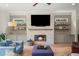 Cozy living room features a stone fireplace, built-in cabinets, and floating shelves with decor at 4048 Navajo Trl, Brookhaven, GA 30319