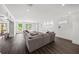 Spacious living room with dark wood floors, recessed lighting, and large sectional couch overlooking the backyard at 4048 Navajo Trl, Brookhaven, GA 30319