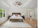 Serene main bedroom with neutral tones, tray ceiling, and hardwood floors, offering a peaceful sanctuary at 4048 Navajo Trl, Brookhaven, GA 30319