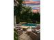 Inviting outdoor patio with a fire pit, comfortable seating, and a waterfall feature into the pool at 4048 Navajo Trl, Brookhaven, GA 30319