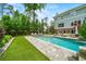 Backyard pool with turf, stone patio, and outdoor seating area at 4048 Navajo Trl, Brookhaven, GA 30319