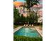 Beautiful backyard featuring a rectangular pool with lounge chairs, a patio, and lush landscaping at 4048 Navajo Trl, Brookhaven, GA 30319