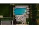Aerial view of a backyard with a rectangular pool, stone patio, outdoor seating, and manicured landscaping at 4048 Navajo Trl, Brookhaven, GA 30319