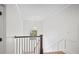 Well-lit staircase with wood flooring and white railings, providing a safe and stylish transition between floors at 4048 Navajo Trl, Brookhaven, GA 30319