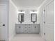 Elegant bathroom featuring double sinks, modern mirrors, and sleek gray cabinetry at 4437 Hosch Reserve Ct, Buford, GA 30519