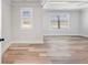 Spacious bedroom with large windows providing ample natural light and luxury vinyl flooring at 4437 Hosch Reserve Ct, Buford, GA 30519