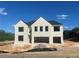 New construction of a two-story brick home featuring a two-car garage and classic architectural details at 4437 Hosch Reserve Ct, Buford, GA 30519