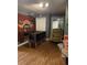 Finished basement with wood flooring and Central Perk themed brick accent wall, offering a cozy and fun living space at 17 Country Walk, Cartersville, GA 30121