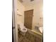 Compact half-bathroom featuring a toilet and pedestal sink, tiled floor, and bamboo shade, with a clean and simple design at 17 Country Walk, Cartersville, GA 30121