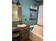 This bathroom features a soaking tub and vanity sink with decor at 17 Country Walk, Cartersville, GA 30121