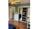 A bedroom featuring wood floors, a baby gate, and a closet organizer system at 17 Country Walk, Cartersville, GA 30121
