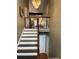 Inviting entryway with hardwood stairs, chandelier, and a decorative wreath on the wall providing an open concept appeal at 17 Country Walk, Cartersville, GA 30121