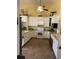Well-lit kitchen featuring white cabinets, tiled floors, and modern appliances at 17 Country Walk, Cartersville, GA 30121