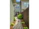 Stone pathway in the backyard, surrounded by wooden fence and healthy green bushes at 239 S Village Sq, Canton, GA 30115
