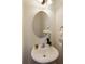 Powder room features a pedestal sink, decorative mirror, and neutral color palette at 239 S Village Sq, Canton, GA 30115
