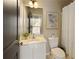 This bathroom has a white vanity, toilet, bathtub with shower curtain, and a neutral color scheme at 239 S Village Sq, Canton, GA 30115