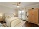 Well-lit bedroom featuring a ceiling fan, bed with plush pillows, and a wardrobe at 239 S Village Sq, Canton, GA 30115