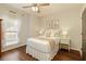 This charming bedroom has hardwood floors, ceiling fan, and natural light at 239 S Village Sq, Canton, GA 30115